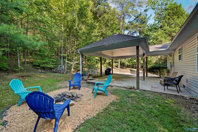 view of yard with a patio and an outdoor fire pit