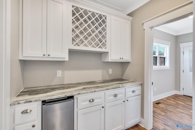 kitchen with crown molding, white cabinets, light stone countertops, and light wood-type flooring