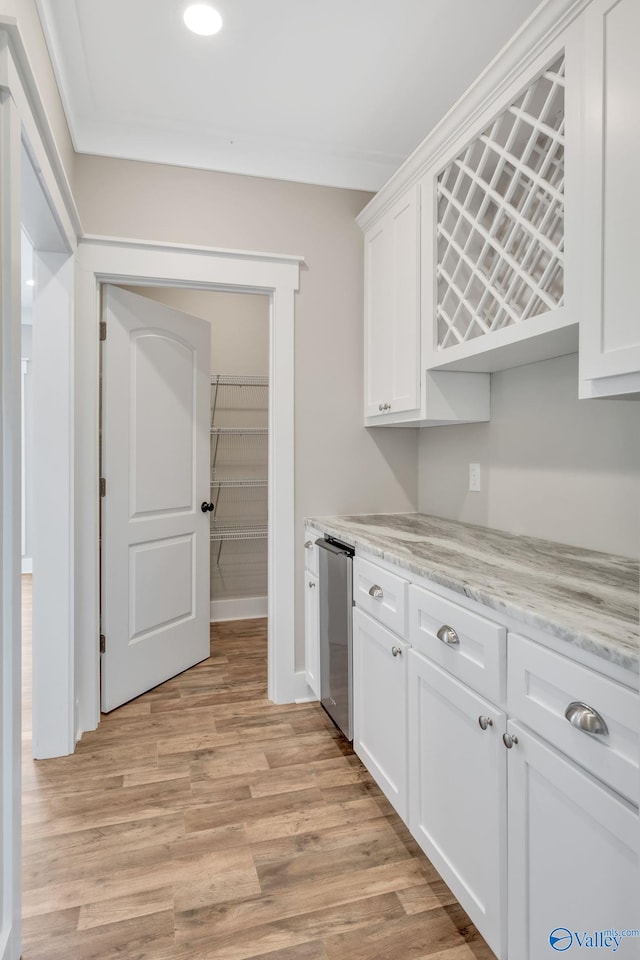 kitchen featuring white cabinetry, light hardwood / wood-style flooring, and light stone counters