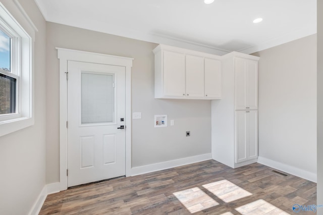 laundry area with cabinets, hookup for a washing machine, dark hardwood / wood-style flooring, and electric dryer hookup