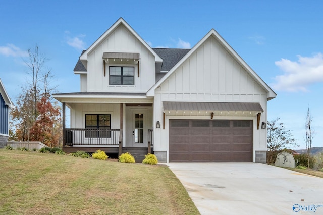 modern inspired farmhouse with a front lawn, covered porch, and a garage