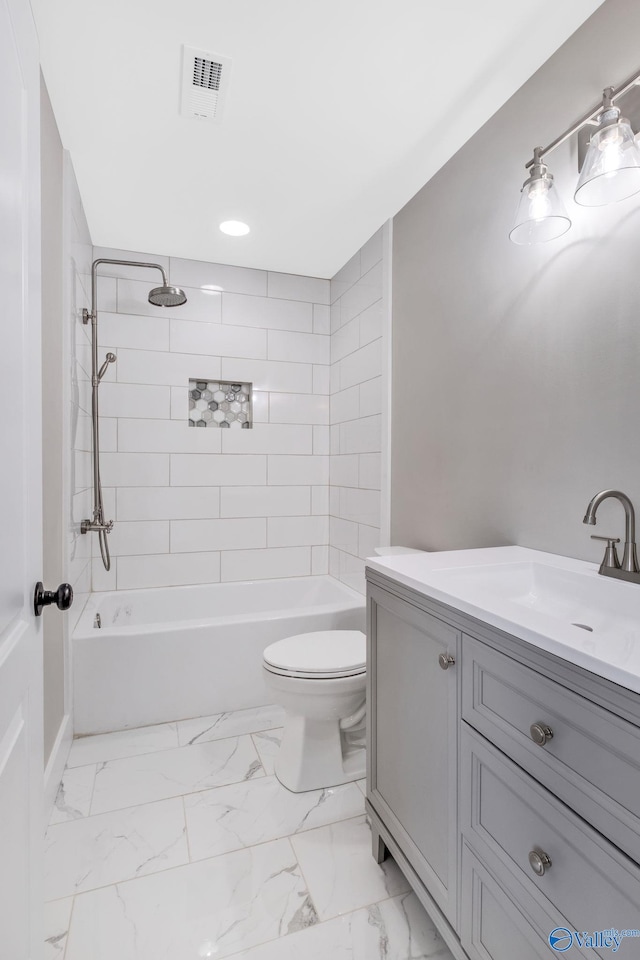 full bathroom with vanity, toilet, and tiled shower / bath combo