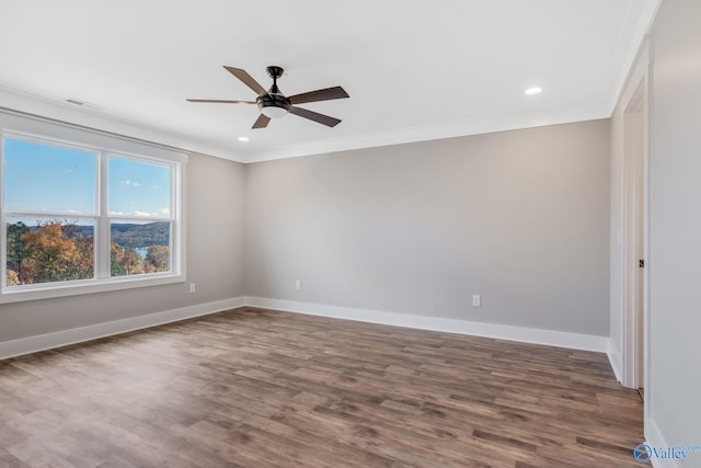 unfurnished room featuring ceiling fan, dark hardwood / wood-style flooring, and ornamental molding