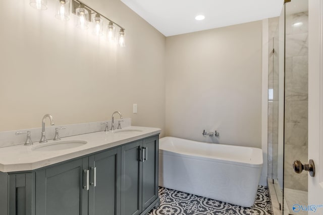 bathroom featuring tile patterned floors, a bathtub, and vanity