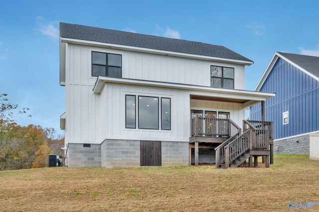 rear view of property featuring a yard and central air condition unit