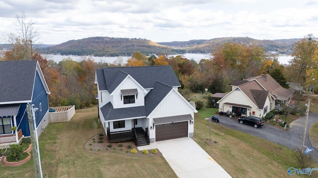 birds eye view of property with a water and mountain view