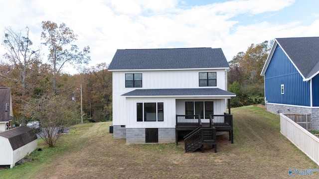 modern farmhouse featuring a front yard and a storage shed