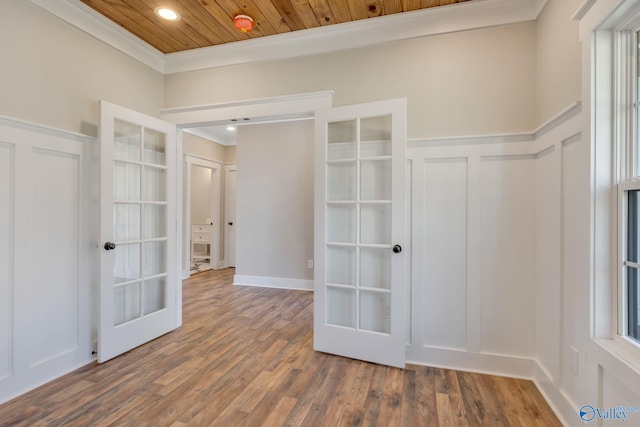 unfurnished room with wooden ceiling, french doors, hardwood / wood-style floors, and ornamental molding