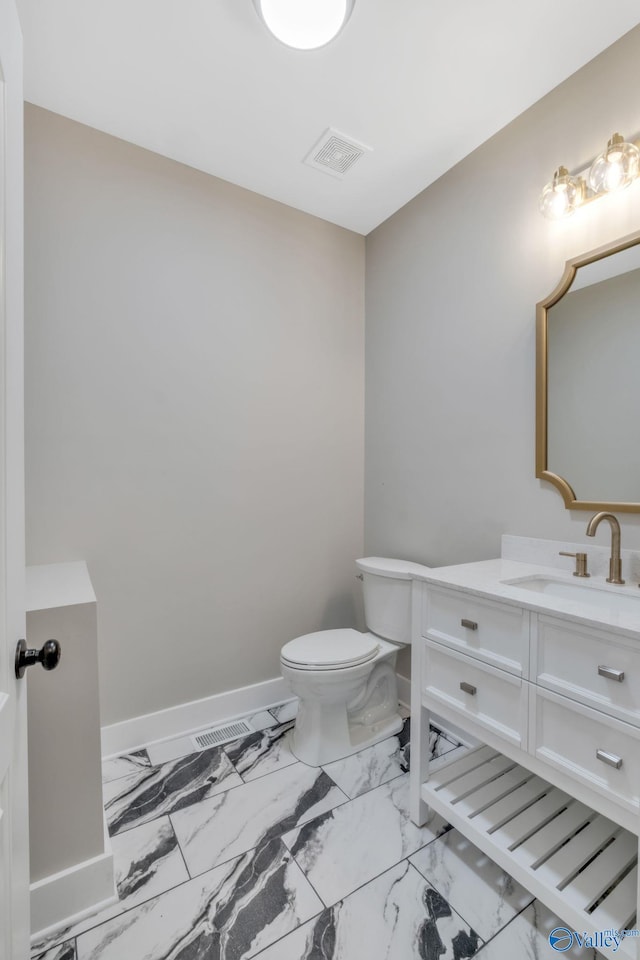 bathroom featuring vanity and toilet