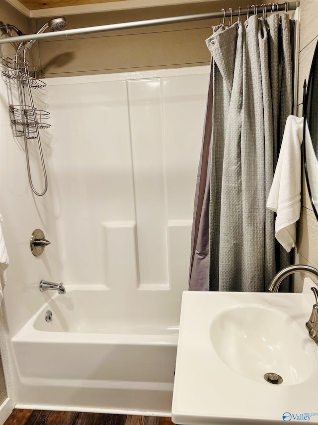 bathroom with sink, shower / bath combination with curtain, and hardwood / wood-style flooring