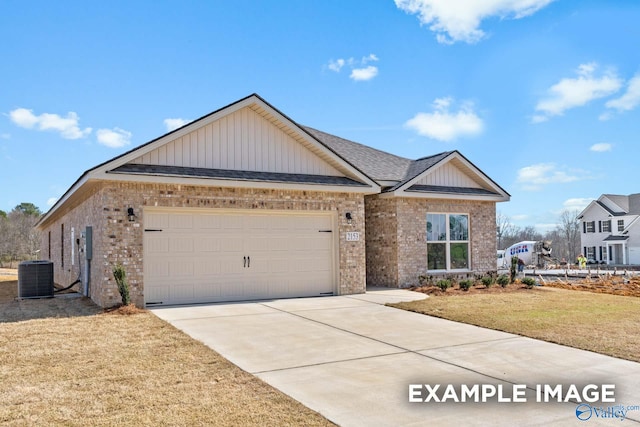 view of front of property featuring central AC, a front yard, and a garage