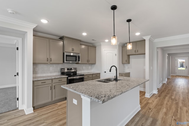 kitchen featuring appliances with stainless steel finishes, hanging light fixtures, backsplash, sink, and light colored carpet