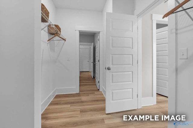 walk in closet featuring light hardwood / wood-style floors