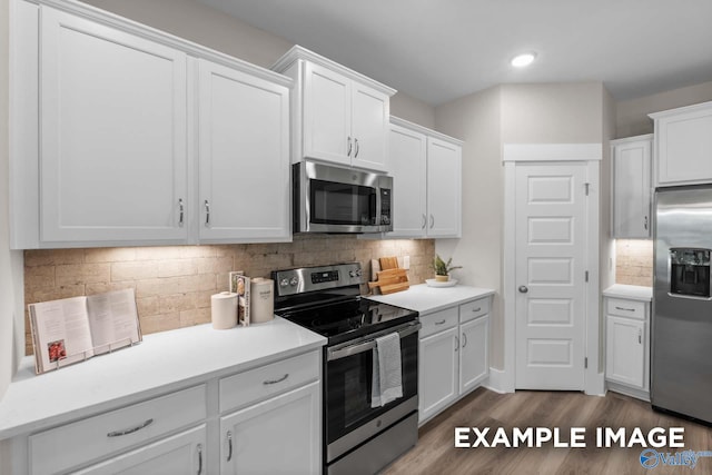 kitchen with tasteful backsplash, light hardwood / wood-style flooring, appliances with stainless steel finishes, and white cabinets