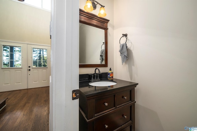 bathroom featuring vanity, wood-type flooring, and french doors