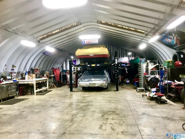 garage featuring a workshop area and a carport