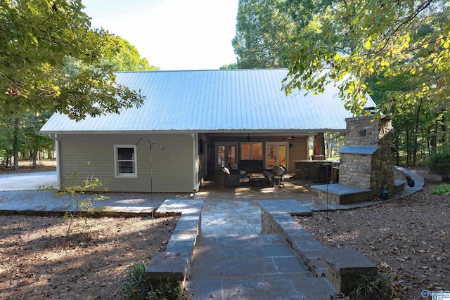 back of house with a patio area and an outdoor living space