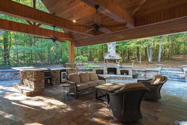 view of patio / terrace featuring an outdoor living space with a fireplace, ceiling fan, and beverage cooler