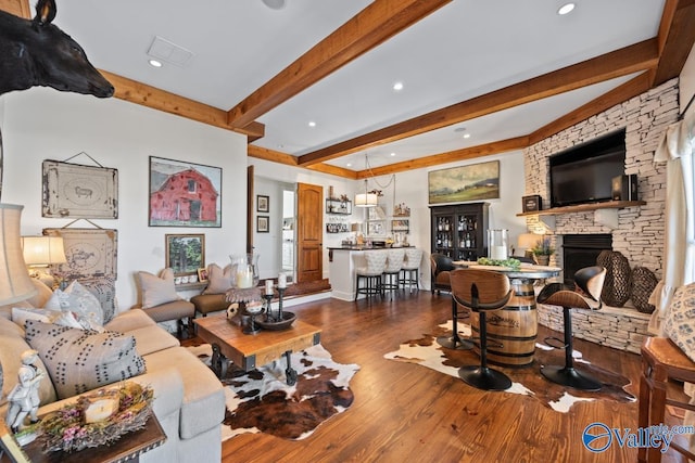 3127 Haddonstone Dr SE, Owens Cross Roads, AL 35763 - living room with beamed ceiling, dark wood finished floors, a stone fireplace, and recessed lighting
