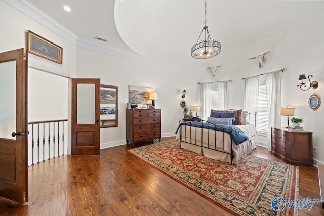 3127 Haddonstone Dr SE, Owens Cross Roads, AL 35763 - bedroom featuring a chandelier, wood finished floors, baseboards, crown molding, and a high ceiling