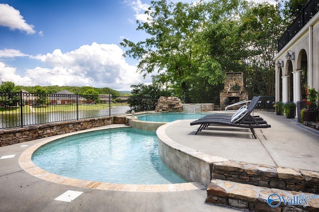3127 Haddonstone Dr SE, Owens Cross Roads, AL 35763 - view of pool with an outdoor stone fireplace, a patio, and a pool with connected hot tub