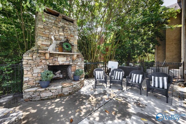 3127 Haddonstone Dr SE, Owens Cross Roads, AL 35763 - view of patio / terrace with an outdoor stone fireplace
