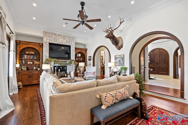 3127 Haddonstone Dr SE, Owens Cross Roads, AL 35763 - living room featuring arched walkways, recessed lighting, a ceiling fan, a fireplace, and wood finished floors