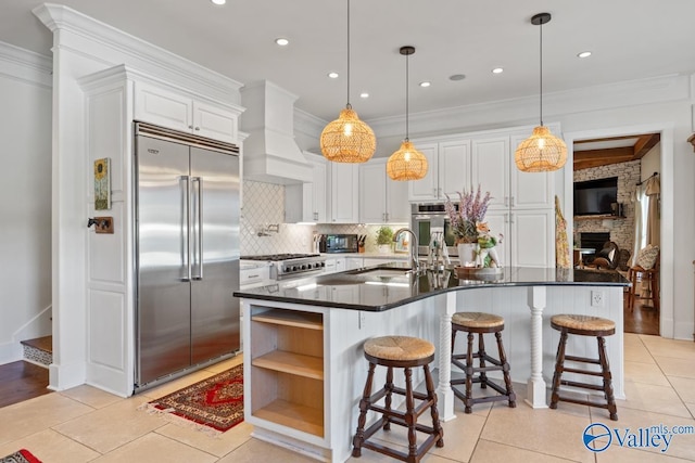 3127 Haddonstone Dr SE, Owens Cross Roads, AL 35763 - kitchen featuring built in refrigerator, a sink, dark countertops, white cabinetry, and decorative backsplash