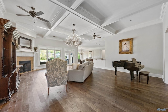 living room with a tiled fireplace, beam ceiling, ceiling fan with notable chandelier, and hardwood / wood-style floors