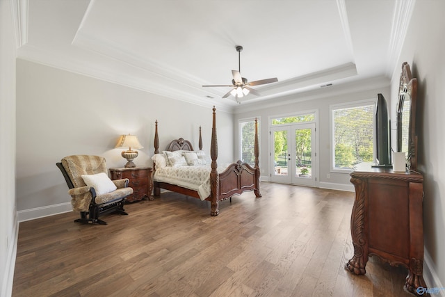 bedroom featuring ornamental molding, wood finished floors, baseboards, access to outside, and a raised ceiling