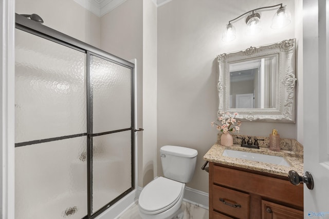 bathroom with vanity, toilet, baseboards, and a stall shower