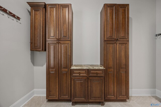 interior space featuring baseboards and tile patterned flooring