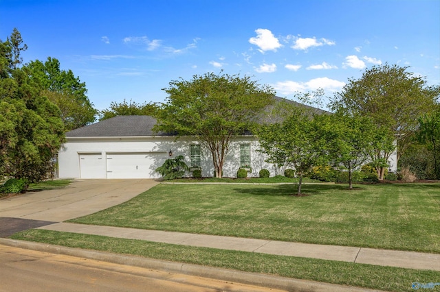 view of front of home with an attached garage, a front lawn, stucco siding, and concrete driveway