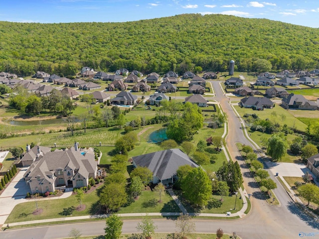 drone / aerial view with a forest view and a residential view