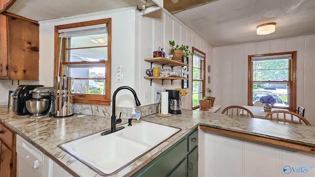 325 Crestview St, Athens, AL 35611 - kitchen with white dishwasher, green cabinetry, light countertops, open shelves, and a decorative wall