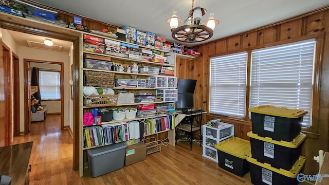 325 Crestview St, Athens, AL 35611 - office with wood finished floors, a chandelier, wooden walls, and attic access