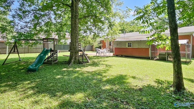 325 Crestview St, Athens, AL 35611 - fenced backyard with a playground and a patio area