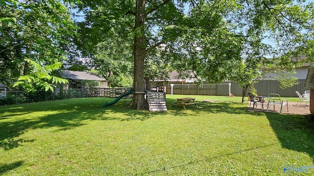 325 Crestview St, Athens, AL 35611 - fenced backyard with a playground and a patio
