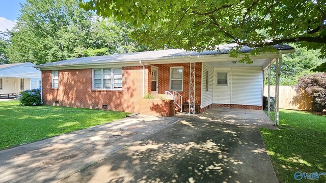 325 Crestview St, Athens, AL 35611 - view of front of home featuring crawl space, concrete driveway, a front lawn, and brick siding