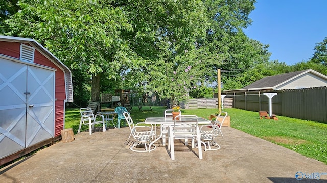 325 Crestview St, Athens, AL 35611 - fenced backyard featuring a patio area, a storage shed, outdoor dining area, and a playground