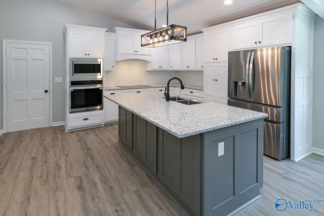 kitchen with light hardwood / wood-style floors, sink, and stainless steel appliances