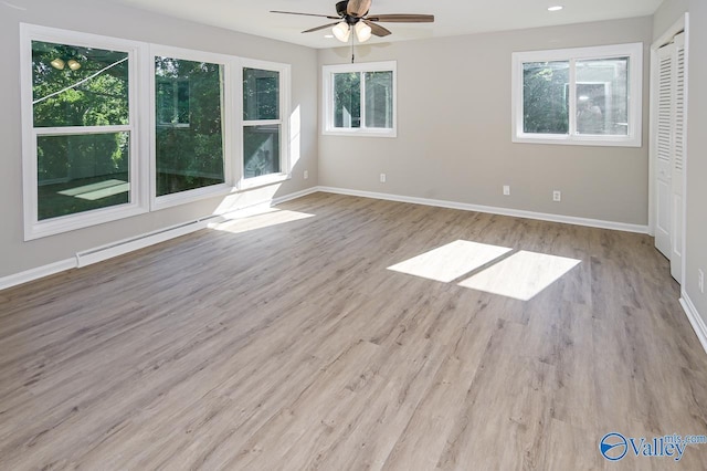 interior space featuring baseboards, wood finished floors, a ceiling fan, and a closet