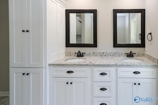 bathroom with double vanity and a sink