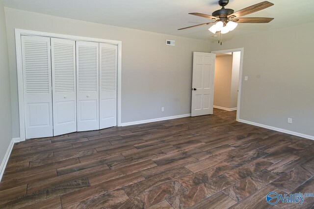 unfurnished bedroom featuring dark hardwood / wood-style floors, ceiling fan, and a closet