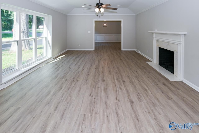 unfurnished living room featuring crown molding, a ceiling fan, vaulted ceiling, and wood finished floors