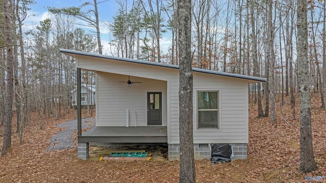 view of side of home featuring ceiling fan