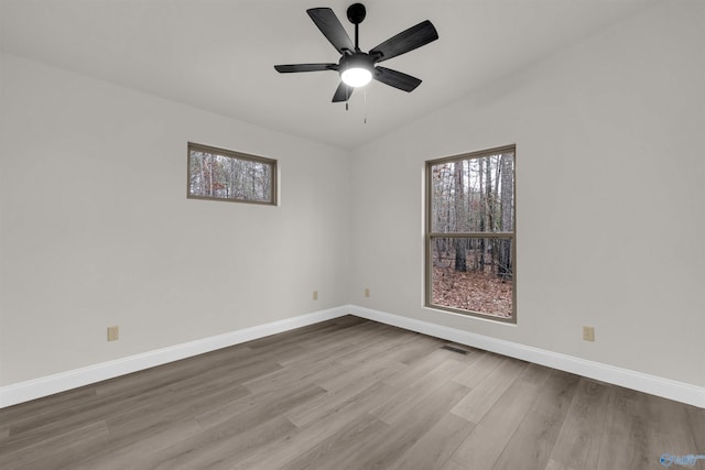 spare room featuring ceiling fan, light hardwood / wood-style flooring, and lofted ceiling