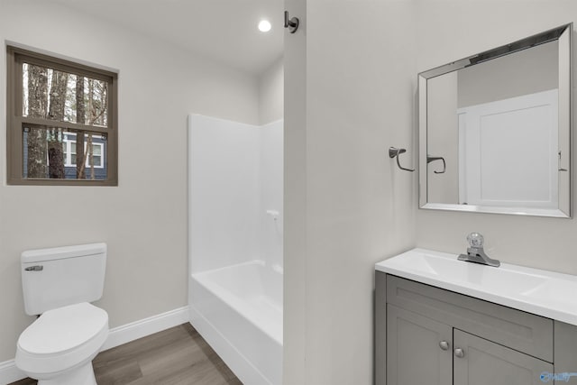 full bathroom featuring shower / bathing tub combination, hardwood / wood-style floors, vanity, and toilet