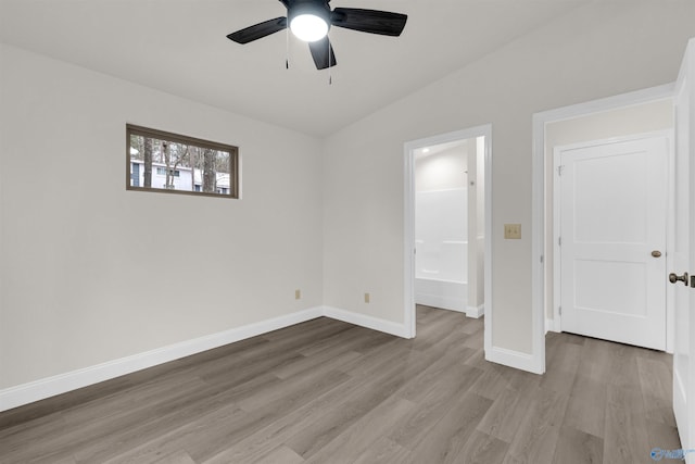 unfurnished bedroom with light hardwood / wood-style floors, vaulted ceiling, and ceiling fan