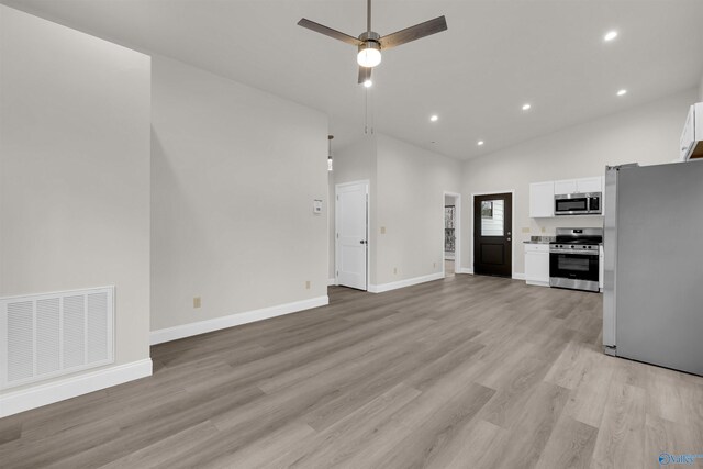 unfurnished living room featuring ceiling fan, high vaulted ceiling, and light hardwood / wood-style floors